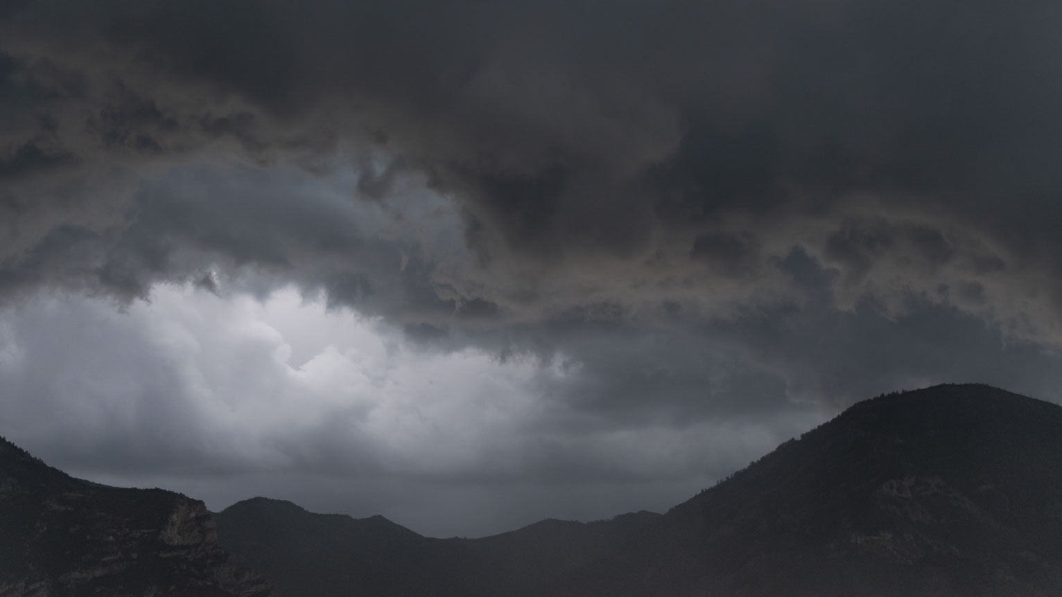 A break in darker rain clouds above the mountains